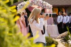 wedding photographer with professional camera working wedding ceremony scaled