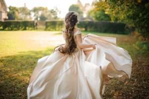 back view beautiful bride spinning wedding dress dancing green field sunny day scaled